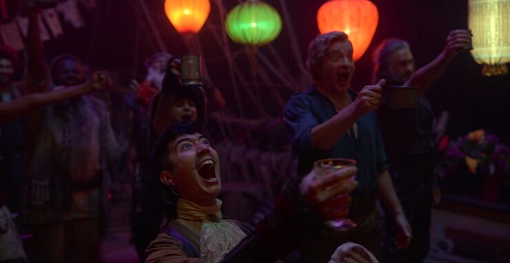 Jim, Stede, Ed, and other characters of Our Flag Means Death cheer for a friend during a party. 